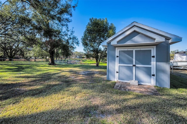 view of outdoor structure featuring a lawn