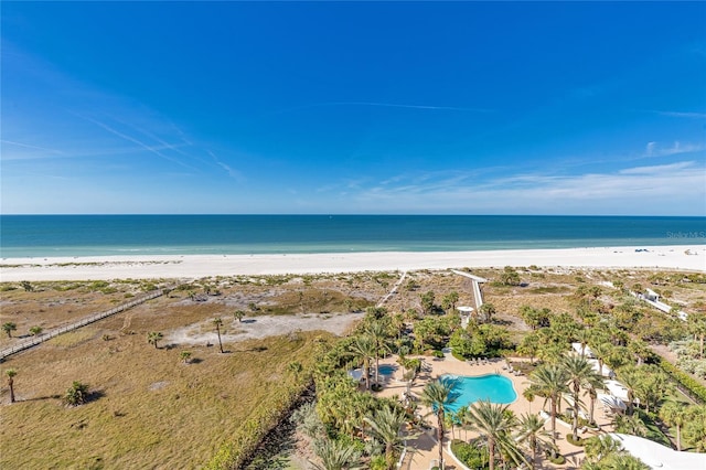 drone / aerial view featuring a beach view and a water view