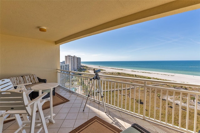 balcony with a beach view and a water view