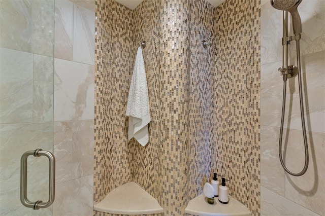 bathroom featuring an enclosed shower and tile walls