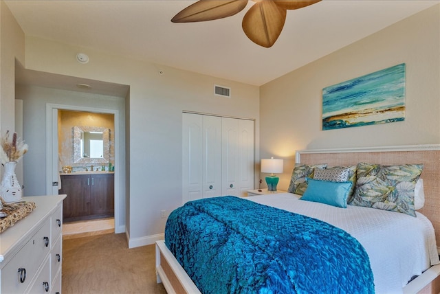 bedroom featuring ceiling fan, light colored carpet, and a closet