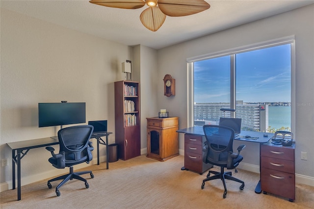 office space featuring light colored carpet and ceiling fan