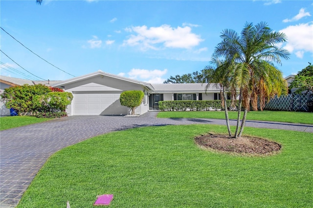 ranch-style house featuring a garage and a front lawn