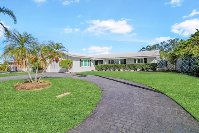 ranch-style house with a garage and a front yard