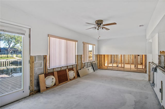 unfurnished living room with light carpet and ceiling fan