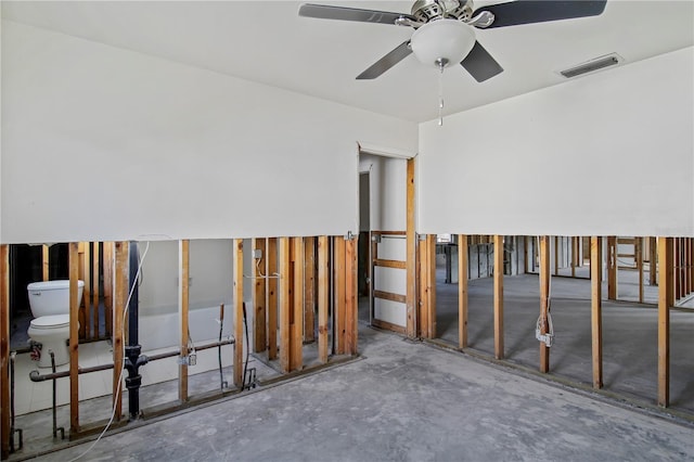 miscellaneous room with ceiling fan and concrete floors