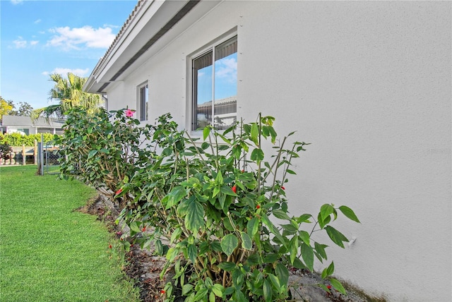 view of side of home featuring a yard