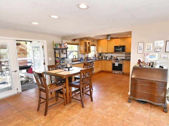 dining space with sink and light tile patterned floors