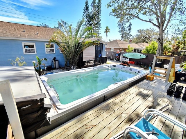 view of pool with a wooden deck