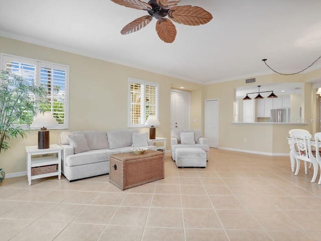 tiled living room featuring ceiling fan and crown molding