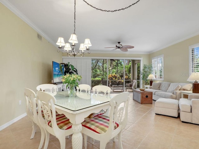 tiled dining room featuring ceiling fan with notable chandelier, a wealth of natural light, and crown molding