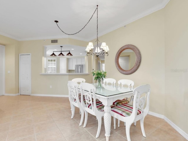 tiled dining area featuring ornamental molding and a chandelier