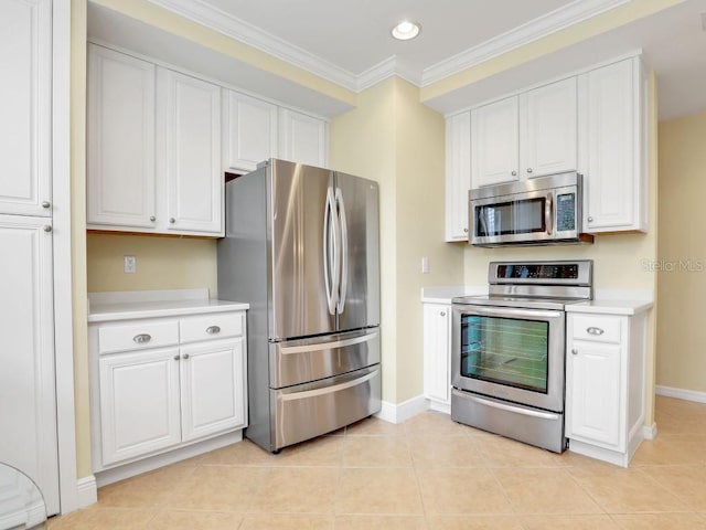 kitchen featuring white cabinets, crown molding, light tile patterned floors, and stainless steel appliances