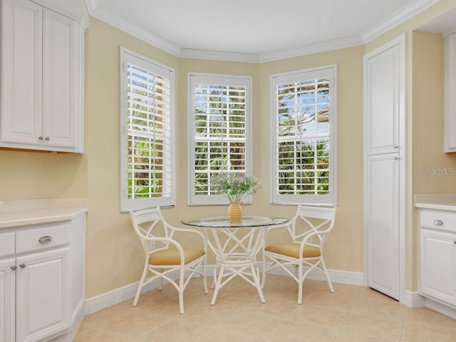 tiled dining area featuring ornamental molding