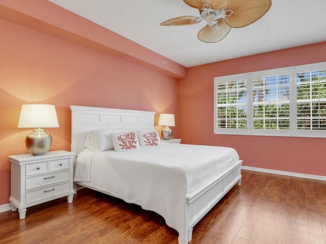 bedroom with ceiling fan and dark wood-type flooring