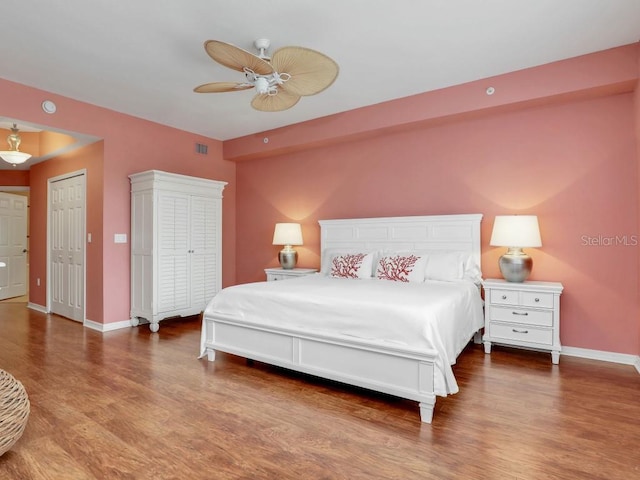 bedroom featuring ceiling fan, a closet, and wood-type flooring