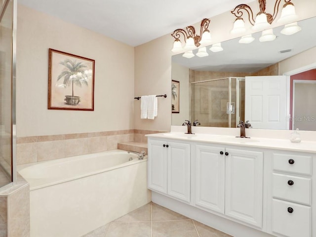 bathroom with tile patterned flooring, vanity, and separate shower and tub