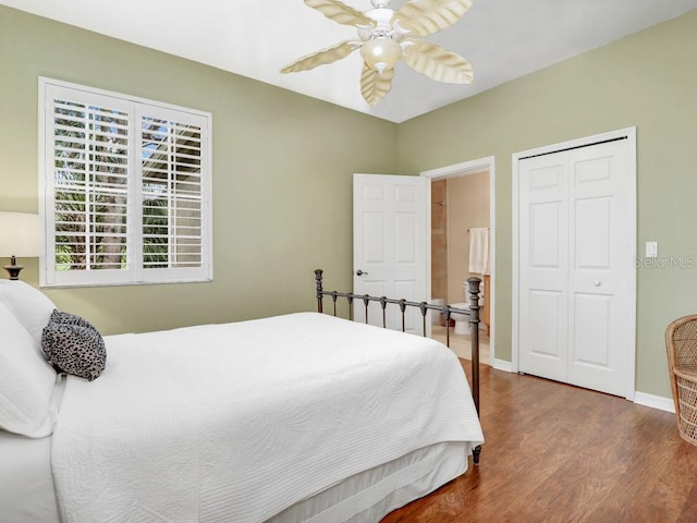 bedroom with ceiling fan, wood-type flooring, and a closet