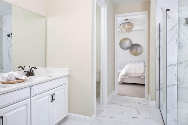 bathroom with a shower with door, vanity, and toilet