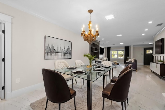 dining room featuring ornamental molding and a notable chandelier