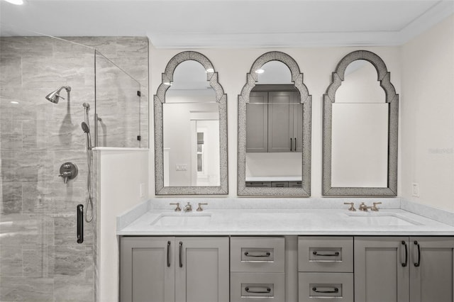 bathroom with vanity, an enclosed shower, and crown molding