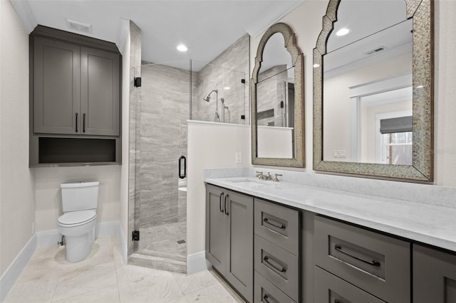 bathroom with vanity, a shower with door, and toilet