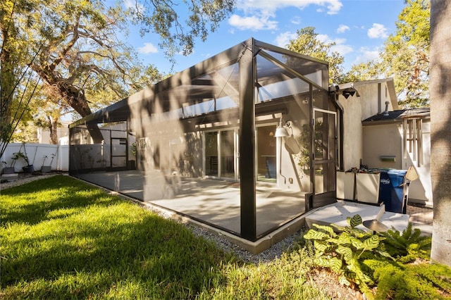 back of house featuring a patio area and a lawn