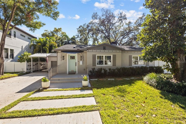 view of front facade with a front lawn and a carport