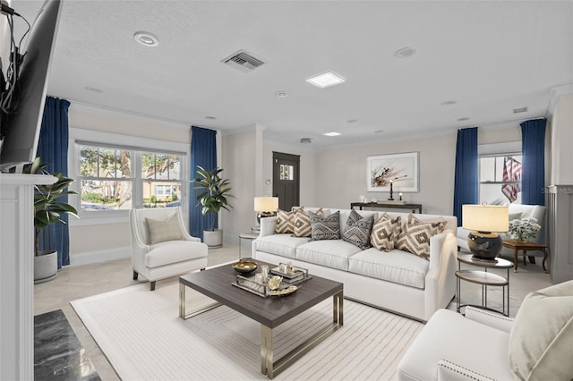 living area featuring plenty of natural light, visible vents, and ornamental molding