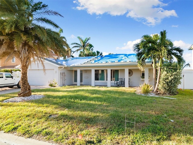 ranch-style home featuring a garage and a front lawn