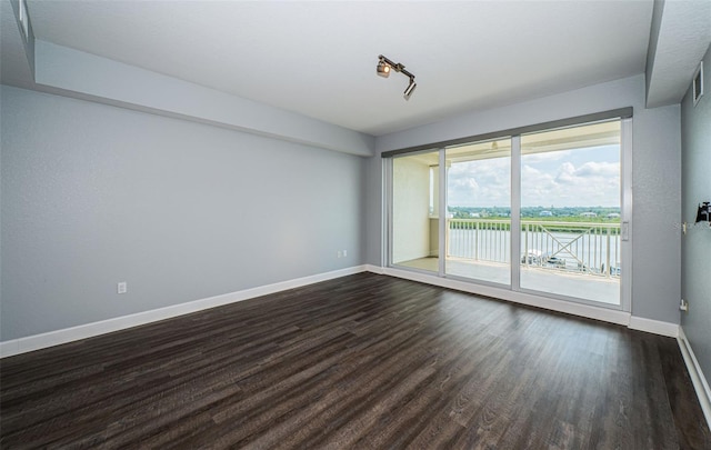 spare room with dark hardwood / wood-style floors