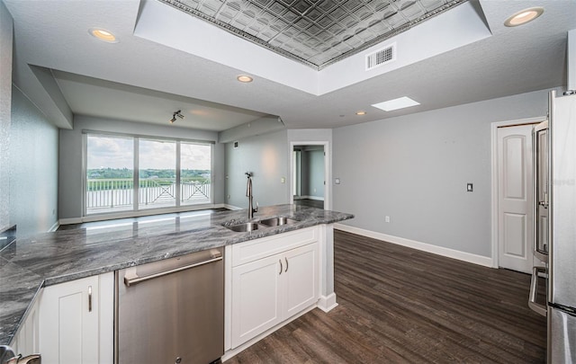 kitchen with white cabinetry, stainless steel dishwasher, dark hardwood / wood-style floors, and sink