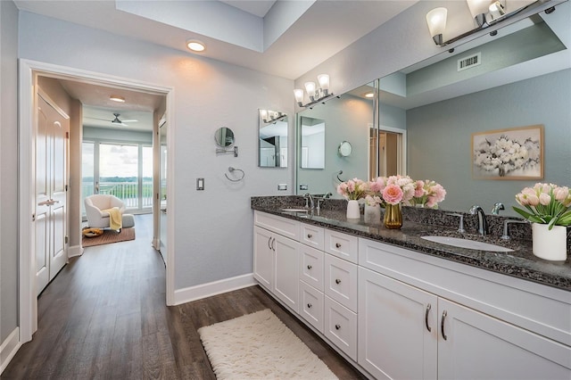 bathroom featuring ceiling fan, hardwood / wood-style floors, and vanity