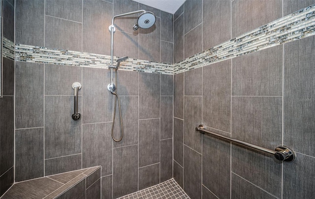 bathroom with a tile shower