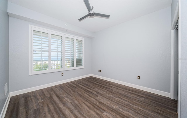 empty room featuring ceiling fan and dark hardwood / wood-style flooring