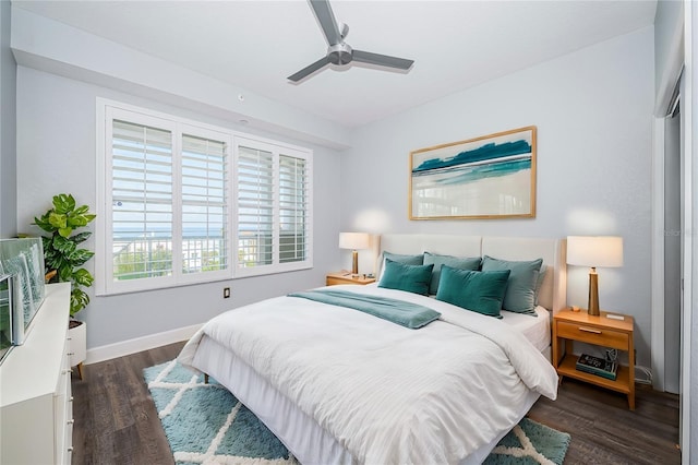 bedroom with ceiling fan and dark wood-type flooring