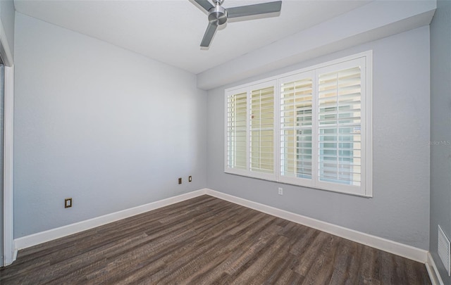 spare room with ceiling fan and dark wood-type flooring