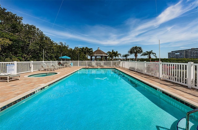 view of pool with a gazebo, a patio, and a hot tub