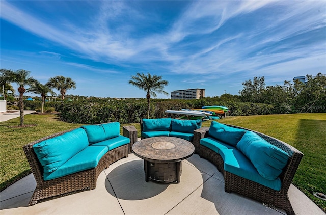 view of patio with an outdoor living space with a fire pit