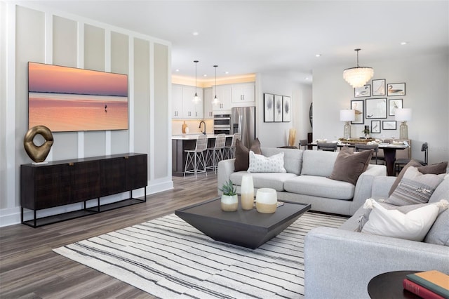 living room featuring dark hardwood / wood-style floors and sink