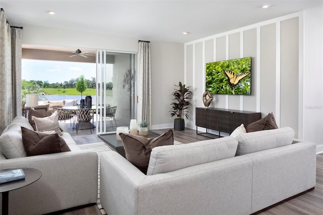 living room featuring ceiling fan and wood-type flooring