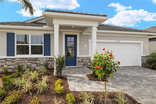 doorway to property with a garage