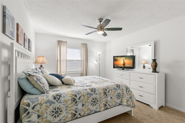 2232 Greenwich Dr Unit 56, Sun City Center, FL 33573 - bedroom with light colored carpet, a ceiling fan, and a textured ceiling