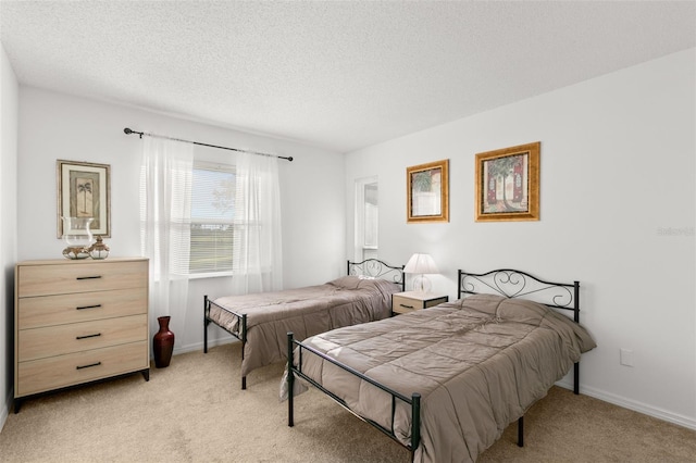 2232 Greenwich Dr Unit 56, Sun City Center, FL 33573 - bedroom with light colored carpet, baseboards, and a textured ceiling