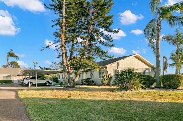 2232 Greenwich Dr Unit 56, Sun City Center, FL 33573 - single story home with a front yard and a carport