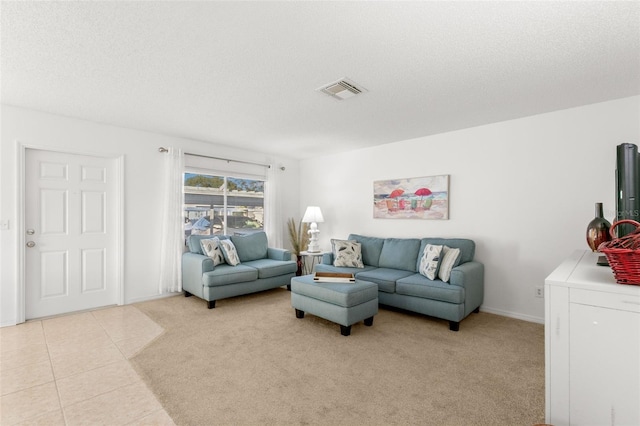 2232 Greenwich Dr Unit 56, Sun City Center, FL 33573 - living room with baseboards, visible vents, light tile patterned floors, and a textured ceiling