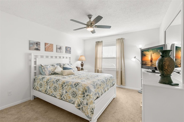 2232 Greenwich Dr Unit 56, Sun City Center, FL 33573 - bedroom featuring a textured ceiling, ceiling fan, light carpet, and baseboards