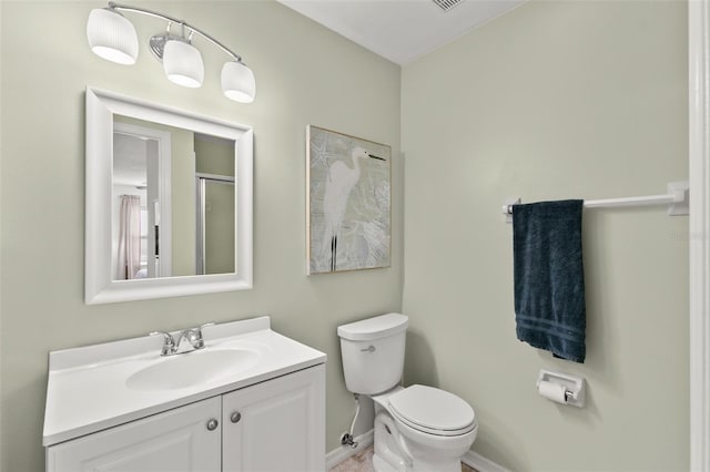 2232 Greenwich Dr Unit 56, Sun City Center, FL 33573 - bathroom featuring toilet, vanity, and baseboards