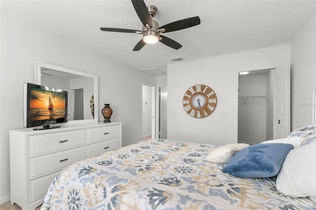2232 Greenwich Dr Unit 56, Sun City Center, FL 33573 - bedroom with a textured ceiling, visible vents, and a ceiling fan