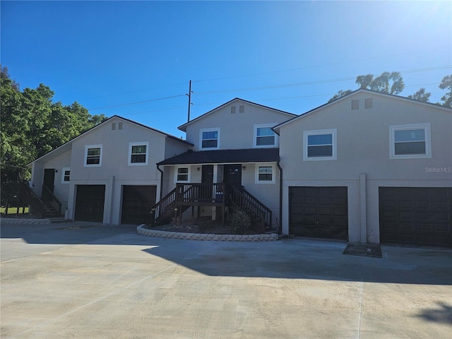 5802 Mohr Loop Unit 5802-5804-5806-5808, Tampa, FL 33615 - view of front of house with an attached garage, stairway, stucco siding, and driveway